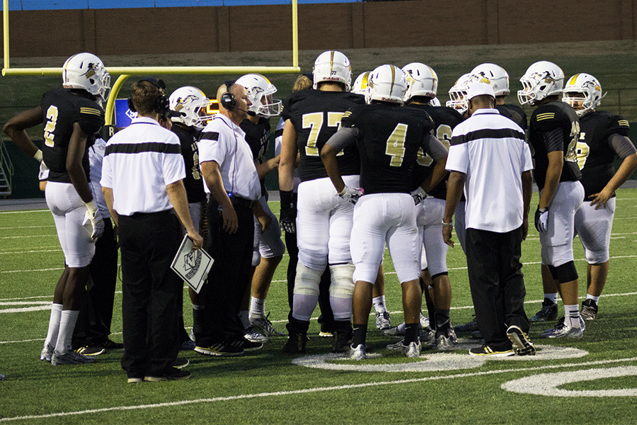 Coach+Robby+Wood+speaks+to+the+offense+line+during+the+Denton+Guyer+game+on+Sep.+11