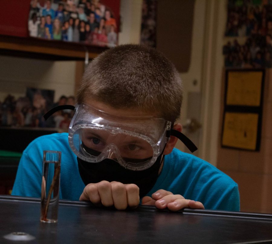 Junior Maverick McKown participates in a lab during a recent Chem Club meeting. 