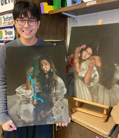 The talented senior, posing with two of his paintings he turned for his AP Drawing portfolio