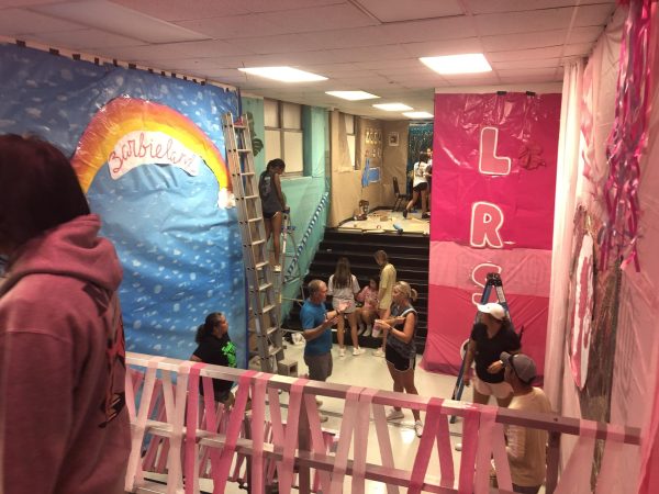 Members of the girls soccer team decorate the main stairwell Saturday in anticipation of Rider-Old High week. 