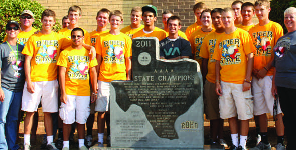 The Rider baseball team, coaches and administrators stand before the state monument that they earned this summer for winning the 4A State Cahmpionship. The monument was delivered to Rider in September.