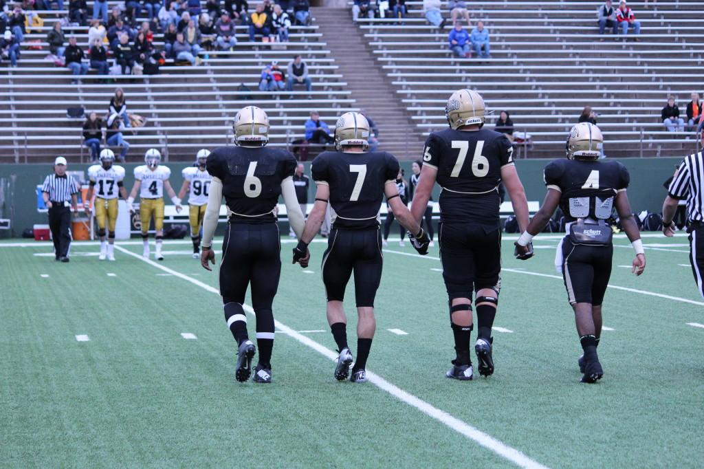 The captains walking onto the field before the 9/14 game against Amarillo.