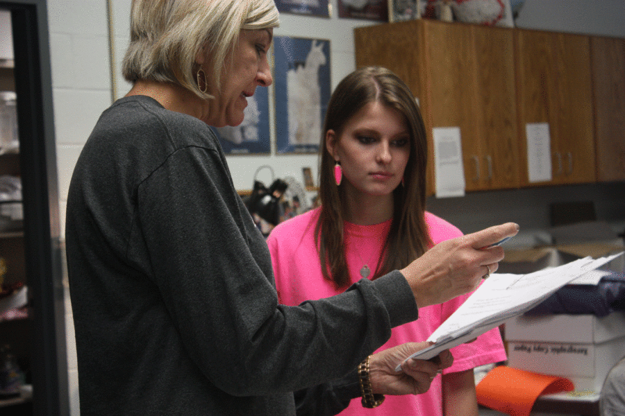 Mrs. M explains what StuCo President Sara Sorge needs to go over during the Wednesday lunch meeting prior to Red Ribbon Week.