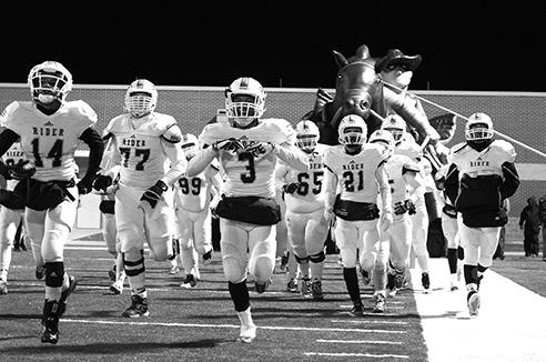 The Raiders run on to the field before a game.