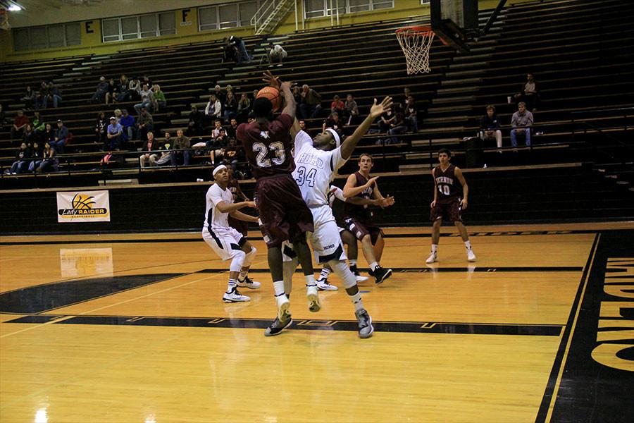 Senior Brien Howard defends against a player from Vernon as the offense shoots for two.