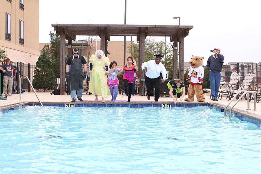 Riders group for the 2015 Polar Plunge leaps into the pool at the Holiday Inn with temperatures reaching down into the 40s. Participants (from left to right) include Mr. Nielsen, Coach Bobbitt, Karla Alvarado, Karla Gonzalez, Coach Francis, and Mrs. Wood. Get to the end as fast as you can, Mrs. Wood told herself as she jumped into the freezing waters. The plunge serves a good purpose, Wood said. It shows just what people are willing to do to raise money and help others.