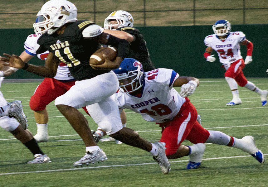 Junior Willie Cherry avoids an Abilene Cooper tackle. Cherry rushed 188 yards and ran for one touchdown in the game and passed for 63 yards. The Abilene Cooper Cougars beat the Raiders 38-32.
