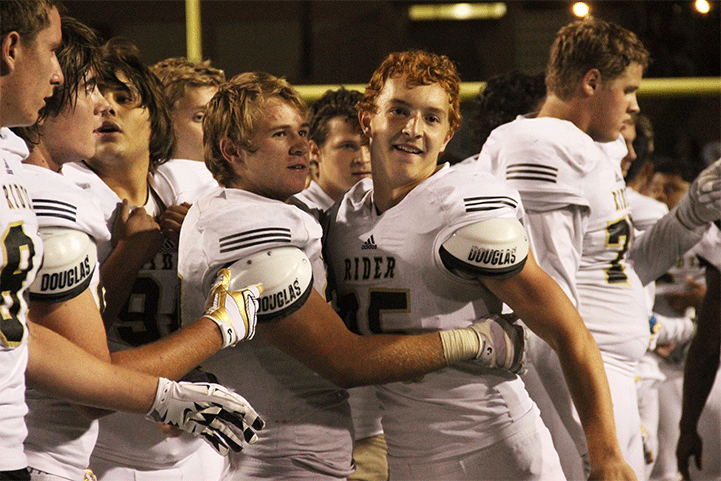 Senior Nick Kulbeth gives Brock Dowling a hug after his game winning field goal scored the last 3 seconds of the game.