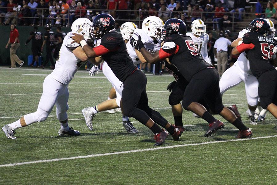 Early in the game, Rider’s defensive line struggles to get past Old High’s offensive line. 