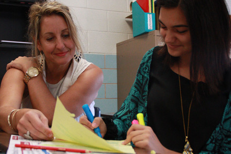 Mrs. Wood  works with sophomore Taryn Bass on her timed writing.