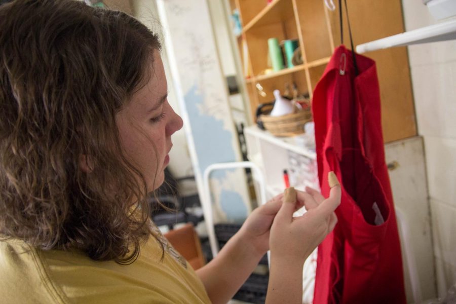 Erin Wisch works on a costume before the performance.