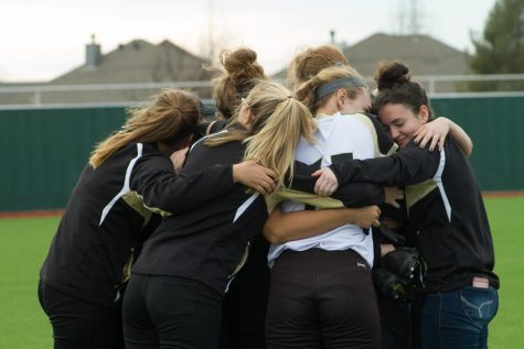 After winning their first game with Coach Graves as the leader, the girls embrace each other.