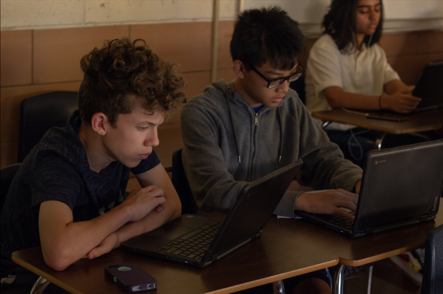 Sophomore+Alex+Preston+and+Jason+Tran+work+on+their+chromebooks.