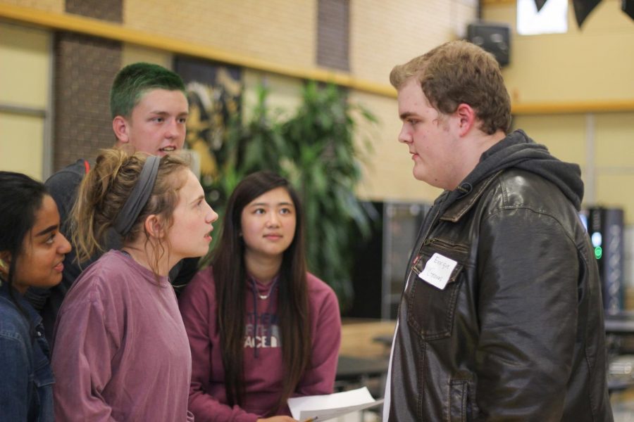 Seniors Jaycee Bruner, Vy Phan, Carson Lee and junior Zayanna Uddin question sophomore Ben Hill, who is playing Enrique Groves, about the murderer. 