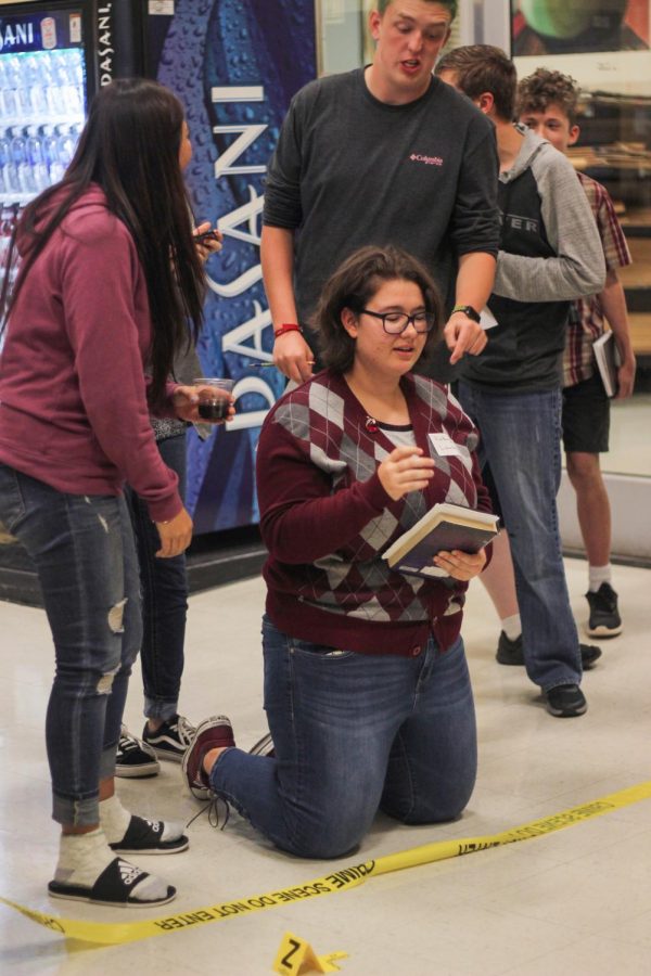 Maddie Nichols tries to crack the case during the first Murder Mystery event in Oct. 2018.