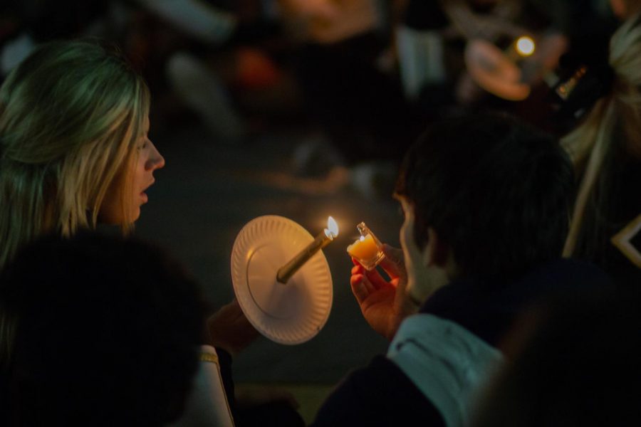Rider students light candles at last year's The Happening. 