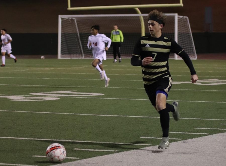 Riders Hagen Sanchez dribbles down the field in a non-district game. 