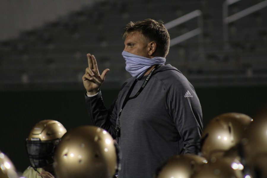 Rider coach Marc Bindel addresses his football team during the recent Midnight Madness practice. 