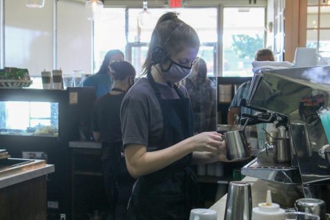 Junior Sydney Haston steams milk at Frank and Joe's. Haston is one of serval Rider students working during the pandemic.