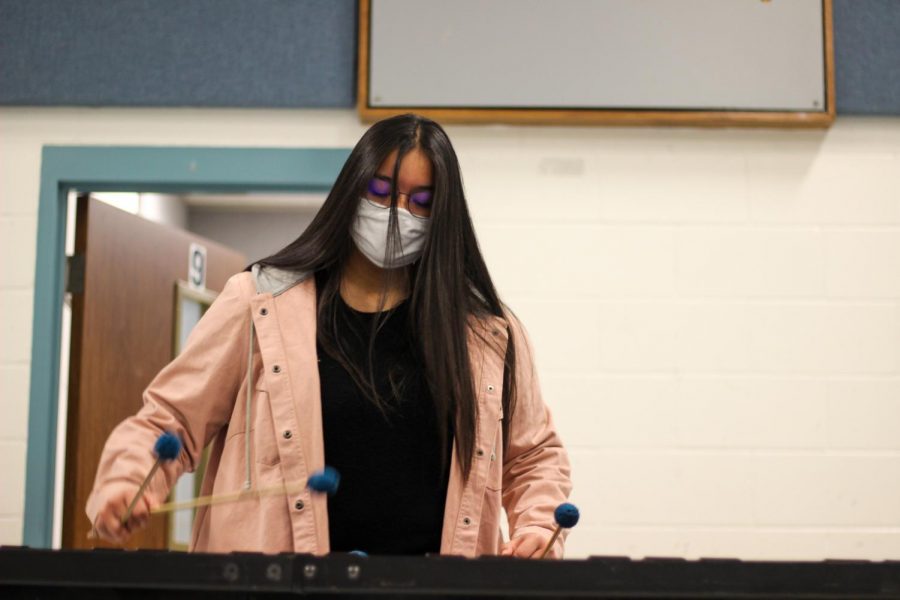 Senior Ana Alvarez practicing in the band hall for her solo.  