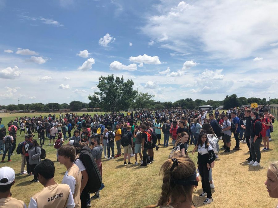 Rider students and staff waiting in designated evacuation area between Rider and Jefferson.