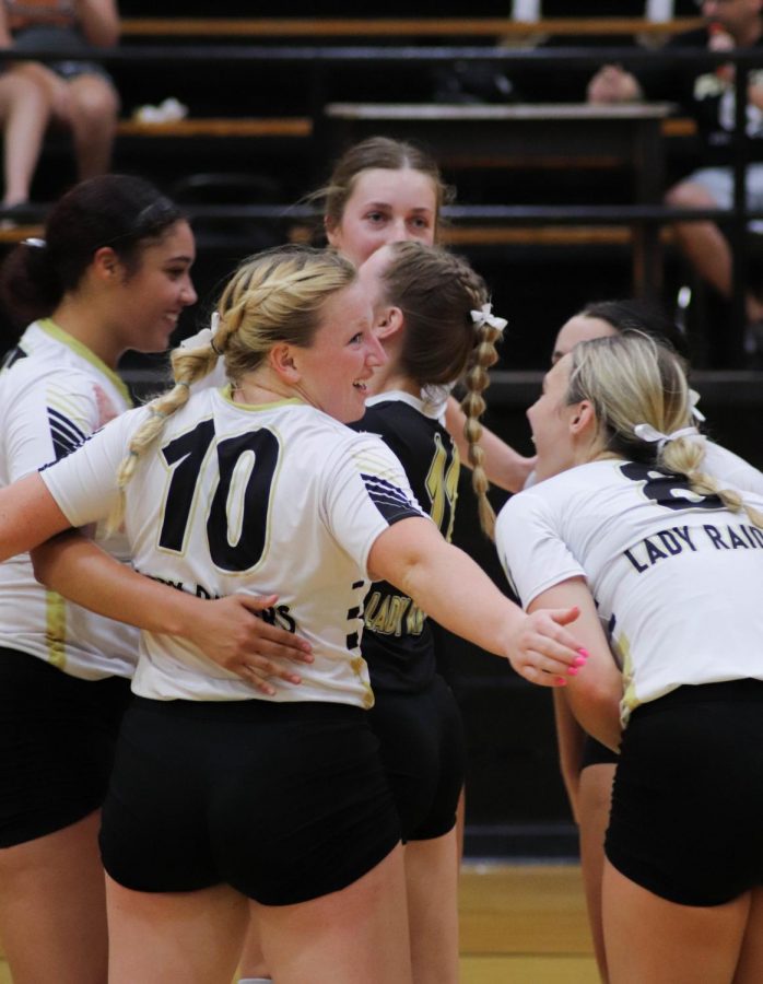 The Lady Raiders celebrate earning a point in a non-district match.