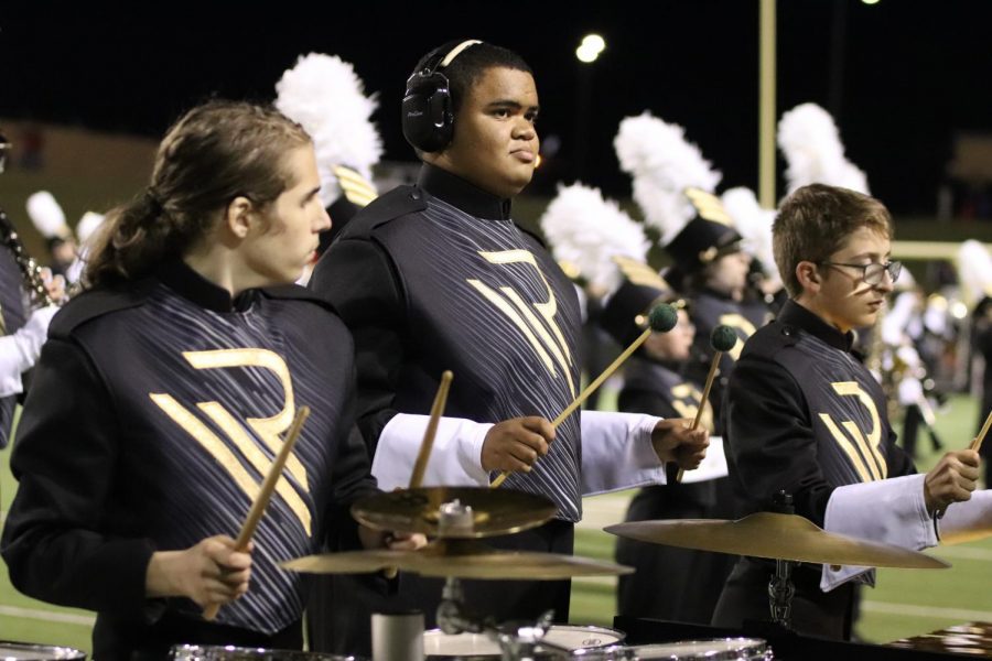 Calob Byrd plays the symbols during the band’s halftime performance at a fall football game. Byrd said his favorite music to play right now is Christmas music.