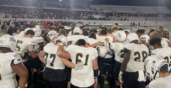 Riders players huddle up one final time after Fridays loss to Lubbock Cooper. 