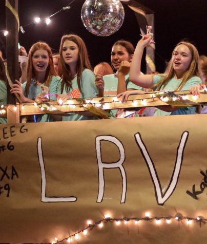 Rider volleyball members ride the LRV Float in The Happening Parade