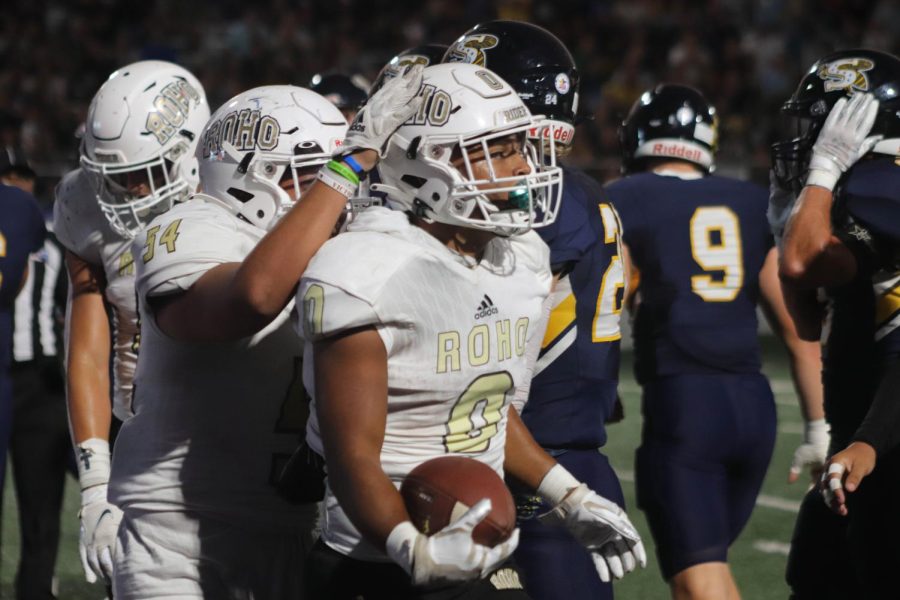 Jordon Gibbs (0) gets a slap on the helmet from offensive lineman Joseph Holst (54) during the game in Stephenville. 