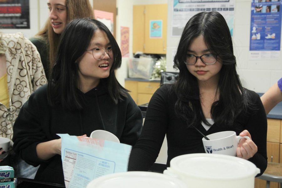 Florances Qiu and Anh Tran make mug cakes during a recent baking club meeting. 