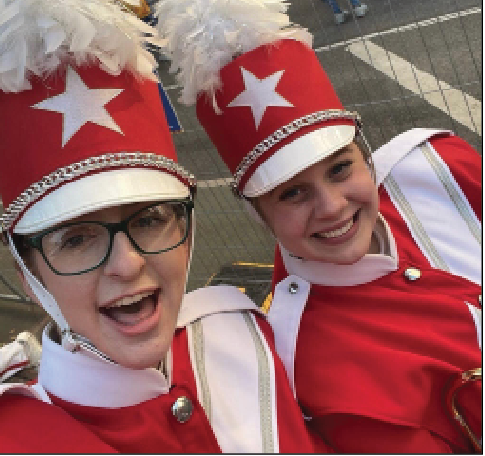 Sarah Beth Johnson and Jordan Tolleson march in the Macy's Thanksgiving parade.