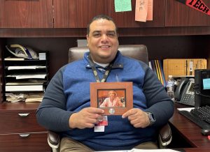 Dr. Troy Farris holds a picture of his late mother Charlye in his office. Farris has worked for WFISD for more than 25 years. 