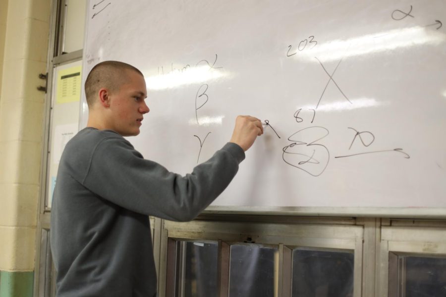 Maverick McKown works out science problems during a UIL practice.