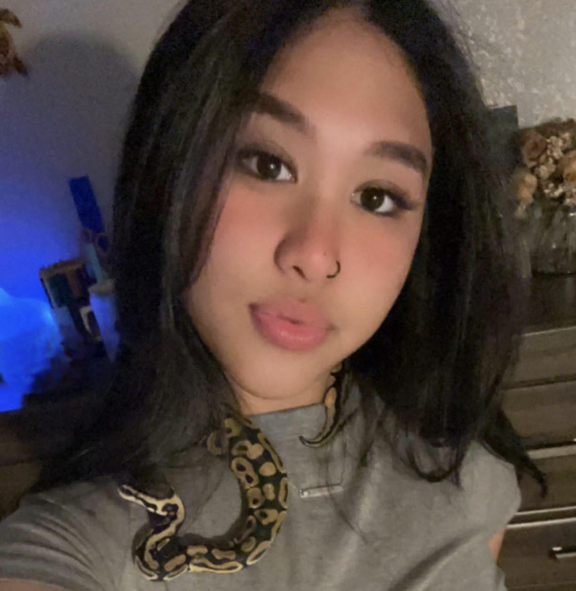 Marley Aguon hold up one of her two different snakes. Aguon also has a tortoise and three dogs as animals. 