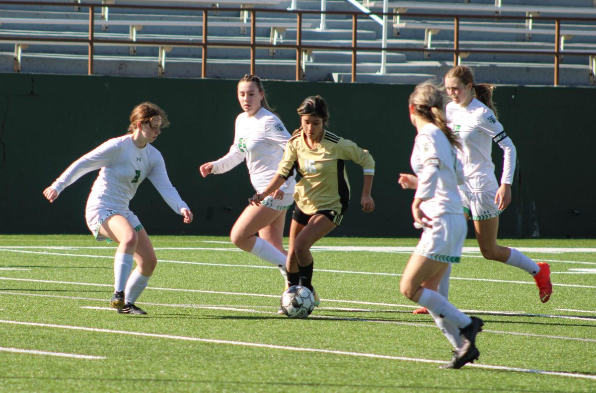 Jimena Rodriguez dribbles through multiple defenders during a game her junior year. 