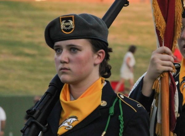 Malea Rierson marches across Memorial Stadium before a Rider football game. Rierson is a female color guard leader as a sophomore. 