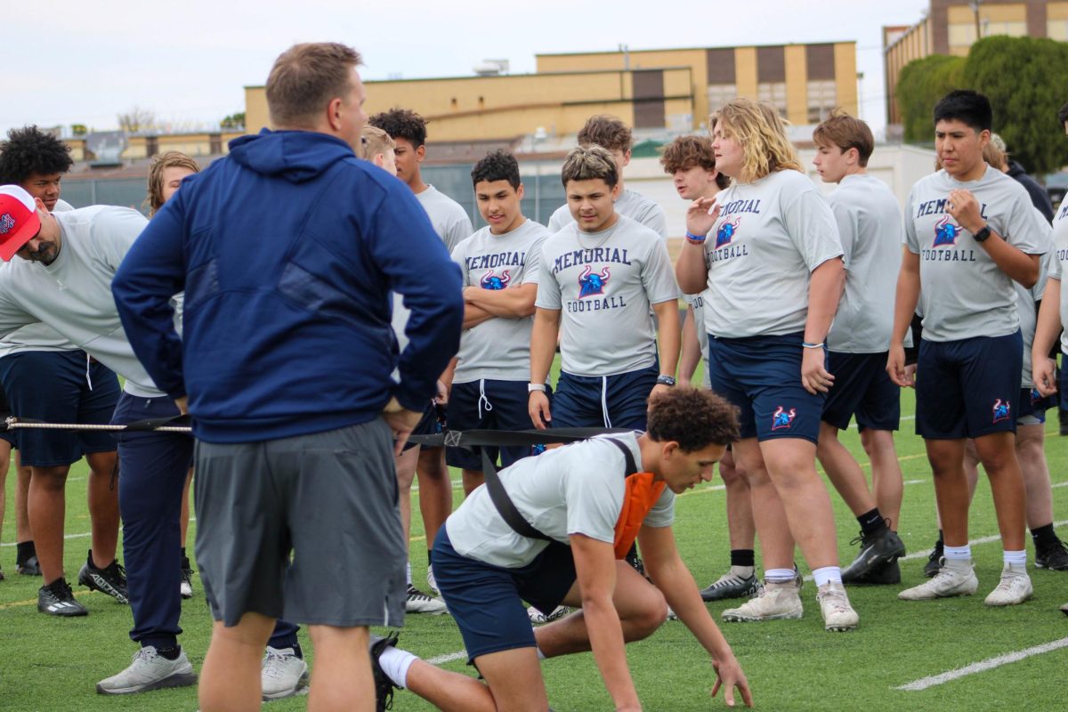 Memorial head football coach Marc Bindel works out with next years Mavericks during fifth period on Friday. 