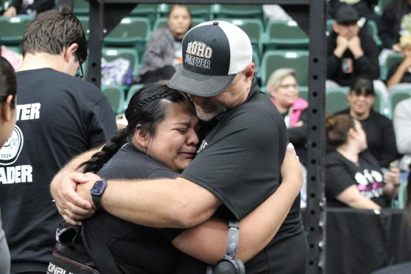 Natasha Cruz hugs Rider coach Billy Davison after winning a state powerlifting title in Class 5A Division II on Saturday at Friscos Comerica Center. 