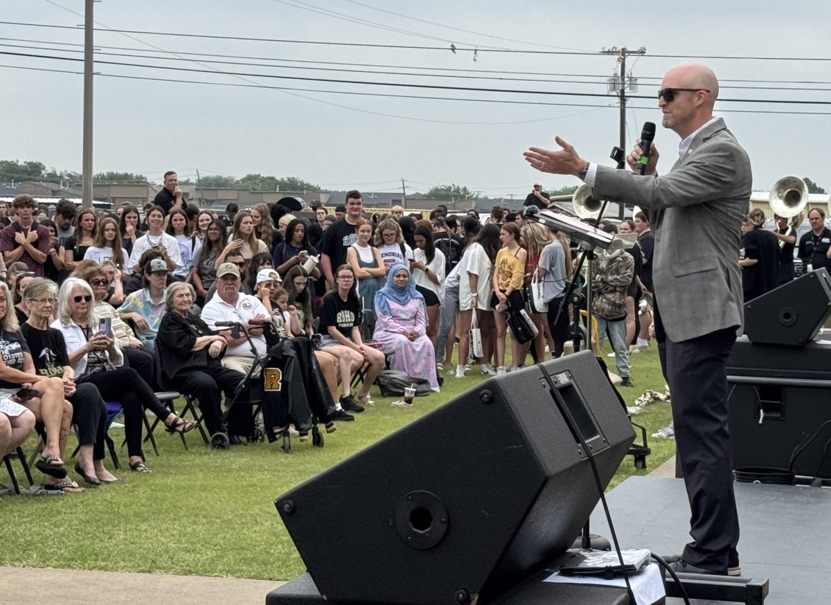 Dr. Cody Blair speaks to an attentive audience at Rider High School's closing ceremony. 