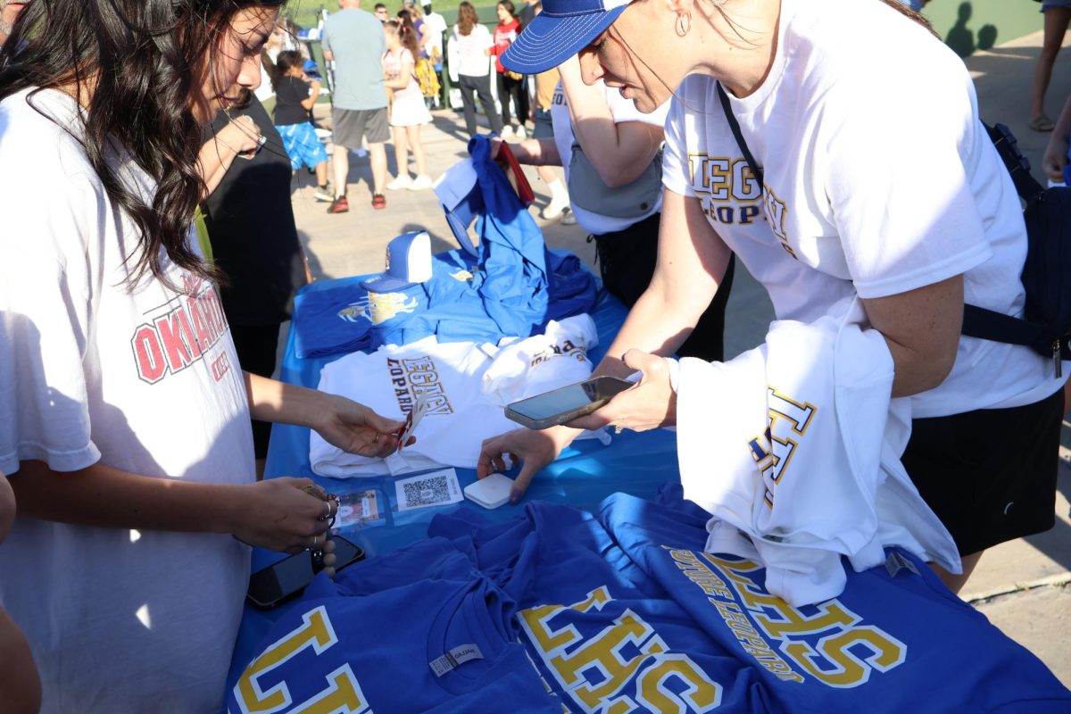 Legacy students buy merchandise at the Sign the Banner event held at Memorial Stadium.  